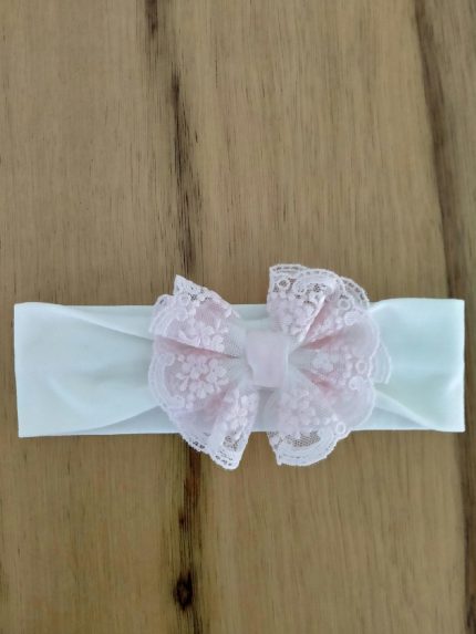 Fascia per capelli Roselline Fascia per capelli in jersey garzato con fiocco rosa in tulle e pizzo. Made in Italy