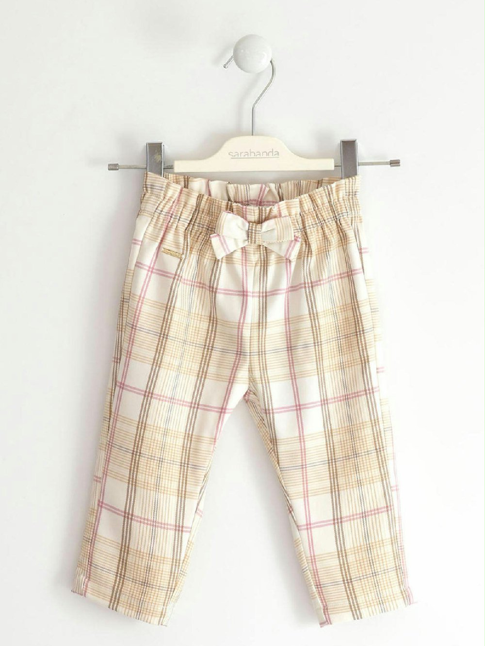 Pantalone in tessuto check bambina 0.5256 00 Pantalone in tessuto check bambina Pantalone per bambina Sarabanda realizzato in tessuto tinto filo con delicata fantasia check. Fiocco davanti e vita arricciata.